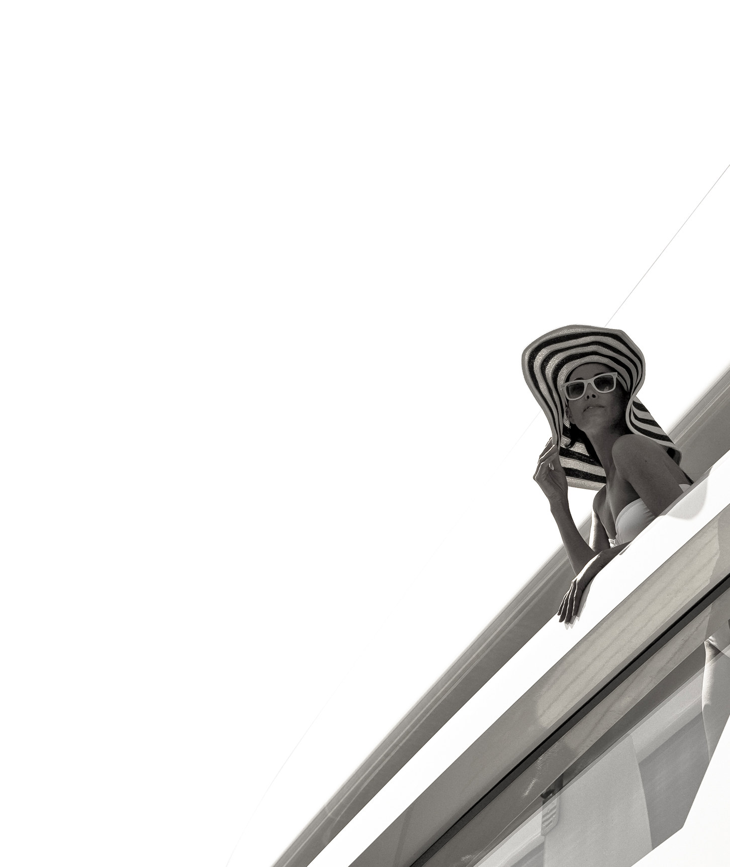 Woman wearing sunhat on balcony.